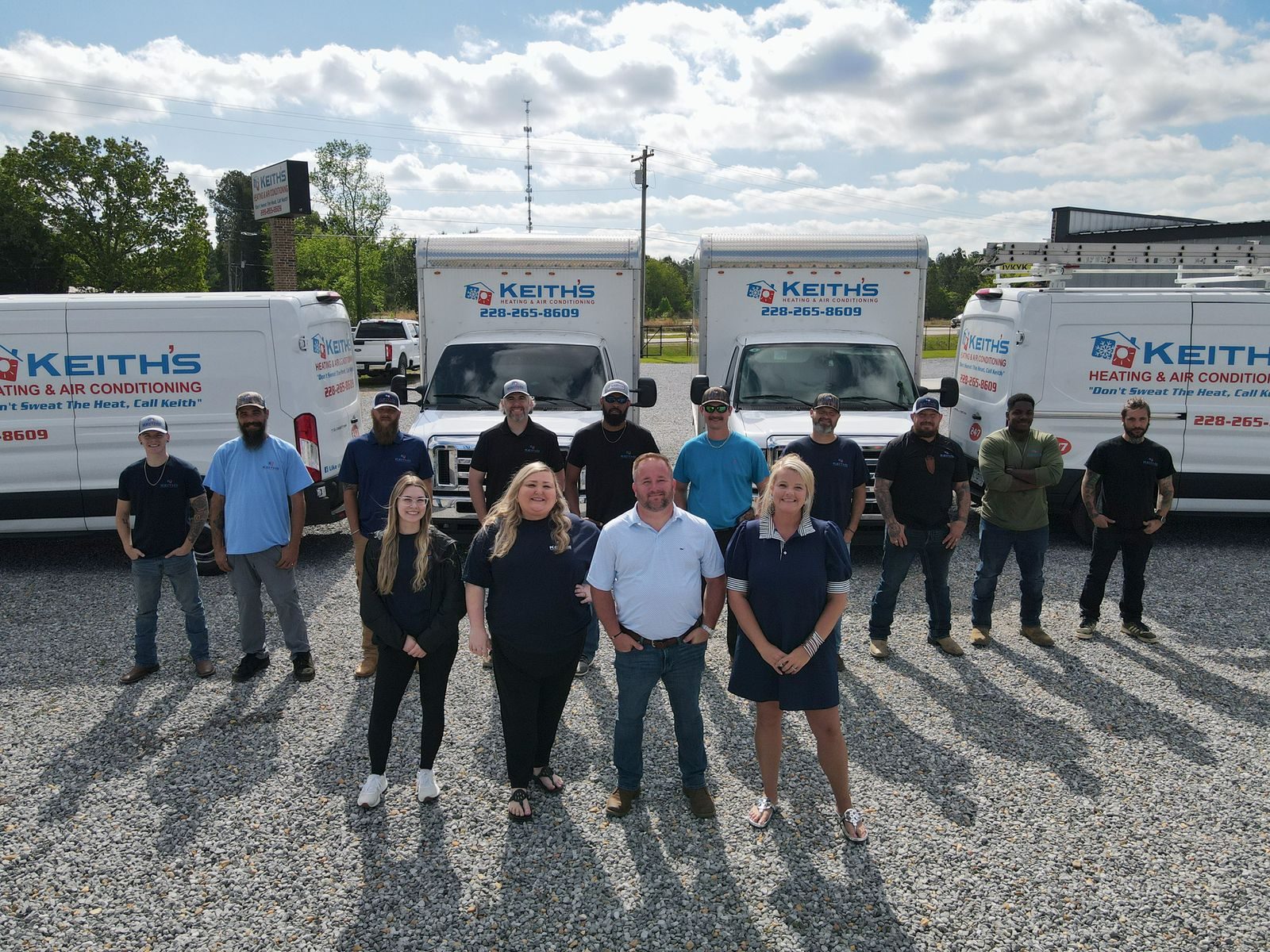 Keith's HVAC full team lineup with fleet trucks
